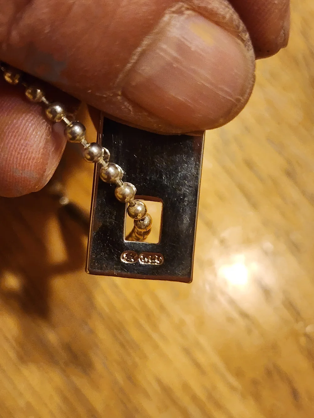 Gucci Sterling Silver Logo Tag likely used on a bracelet or keychain